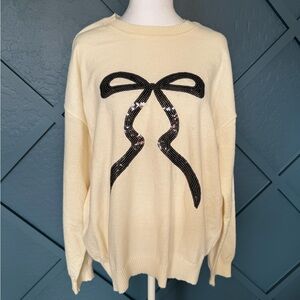 Timing Sweater with sequined bow accent. Perfect for the holidays!